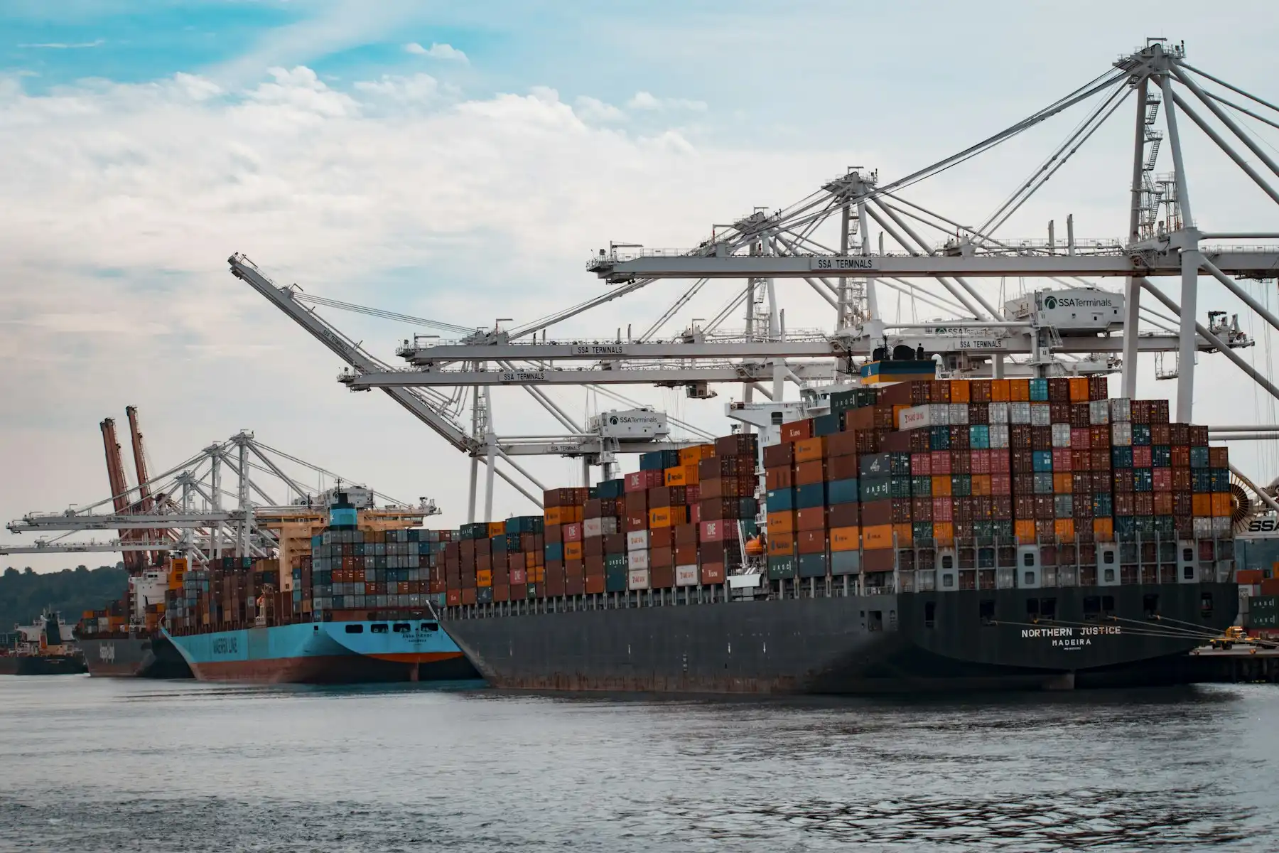 Container ship loaded with cargo at sea