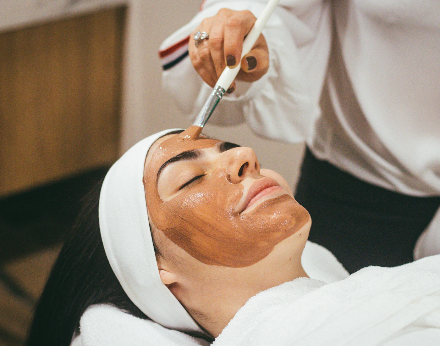 A professional applying a cosmetic treatment