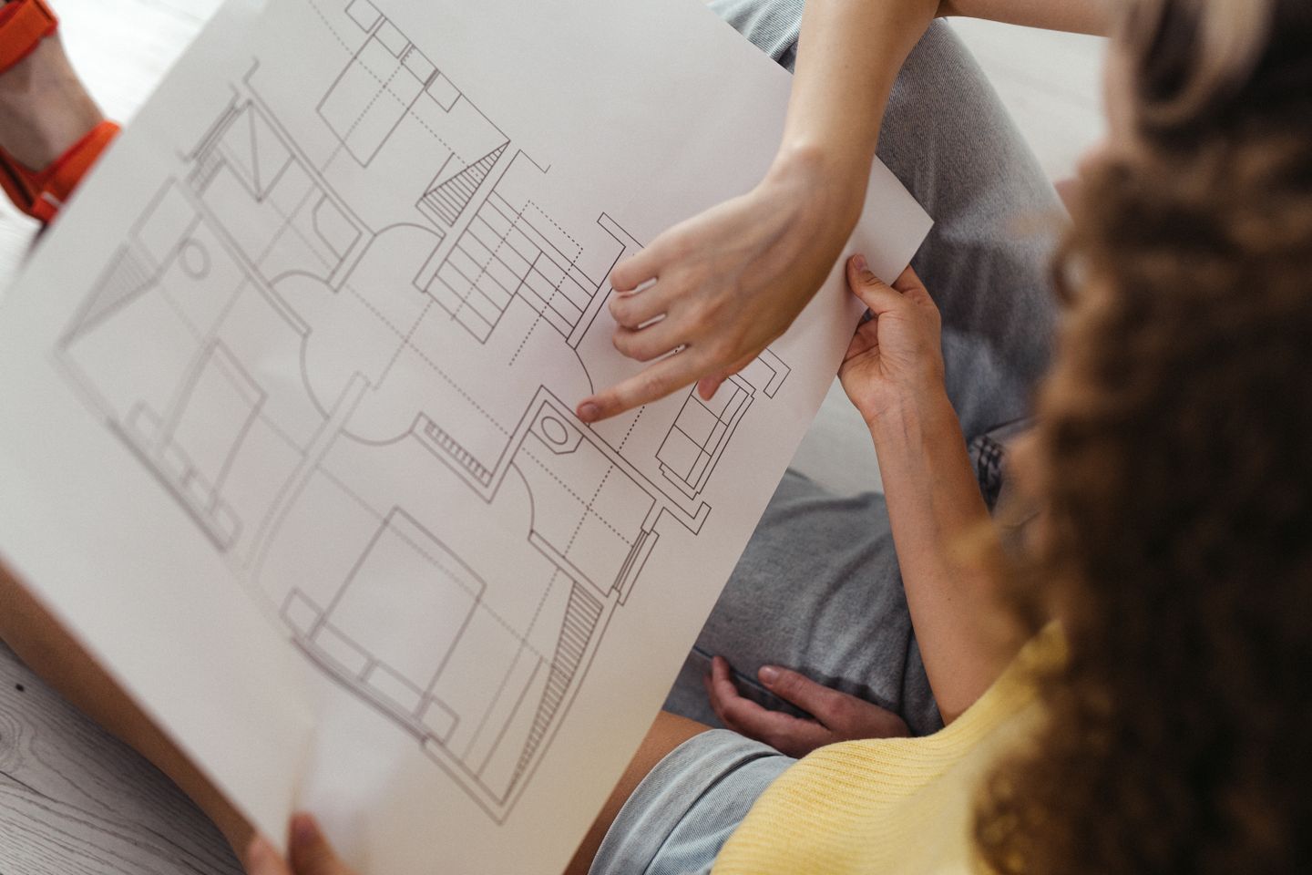 Advisory consultation reviewing property floor plans