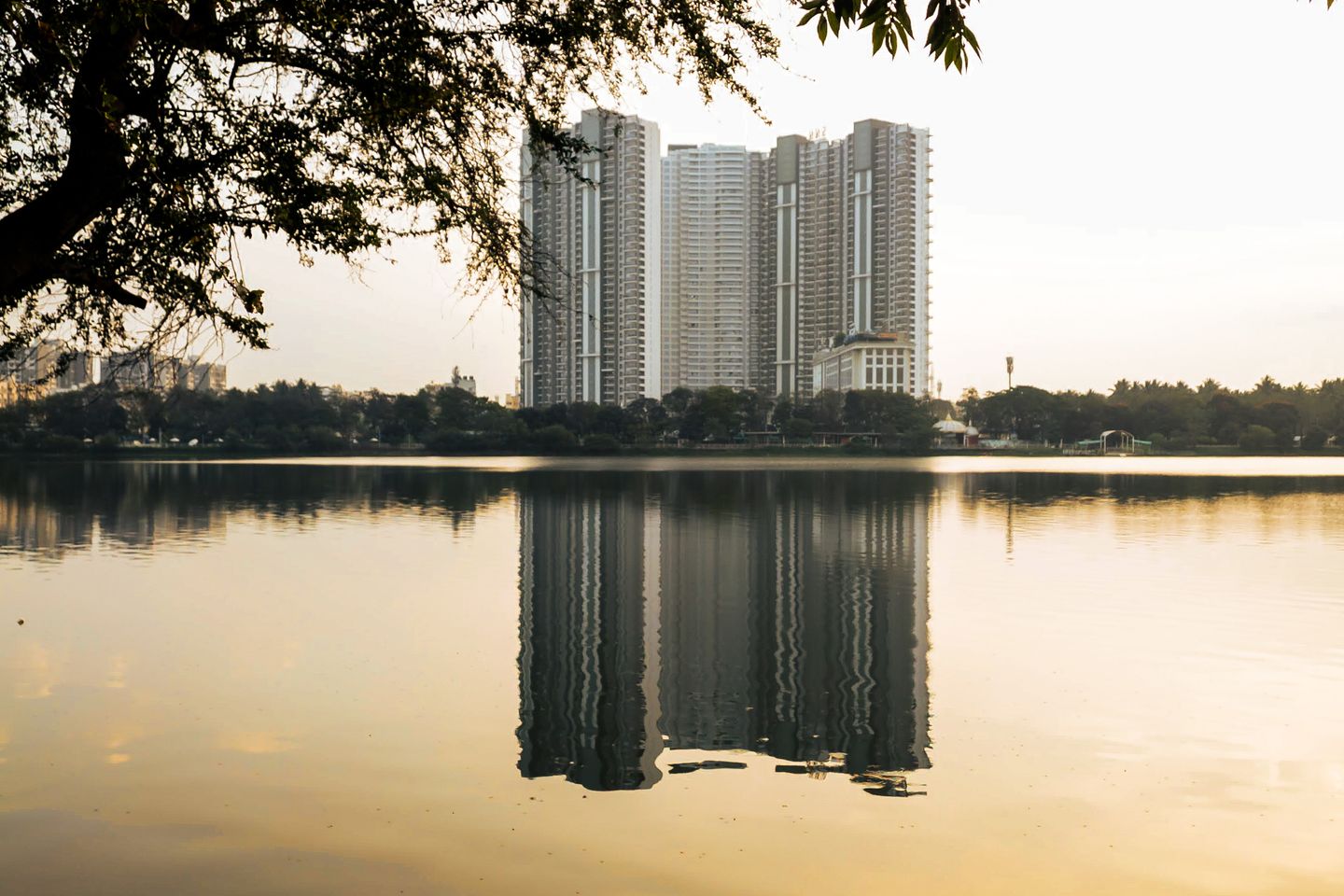Bengaluru skyline reflected in Nagavara Lake at sunset