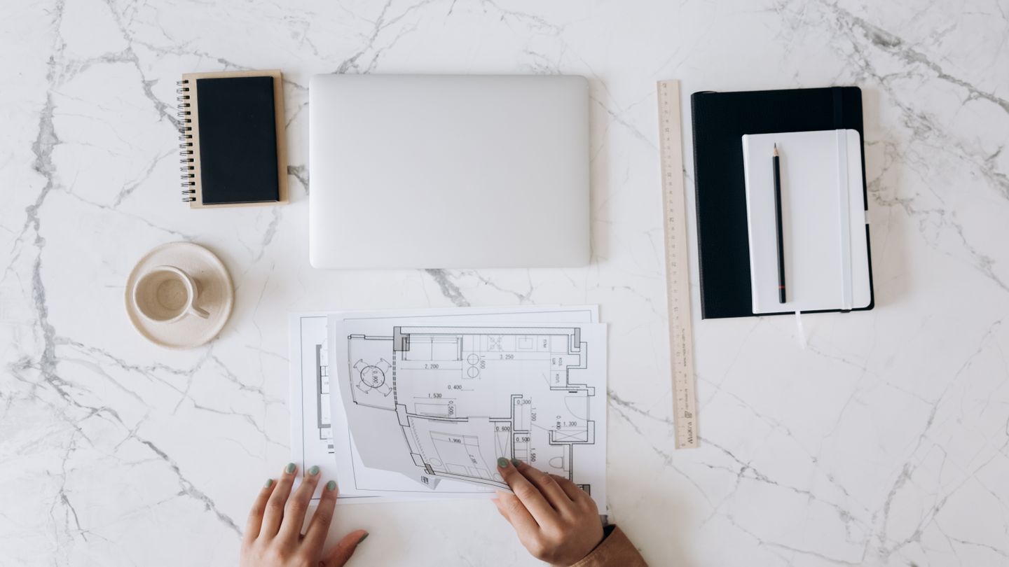 Architectural plans and measuring tools used to evaluate a property