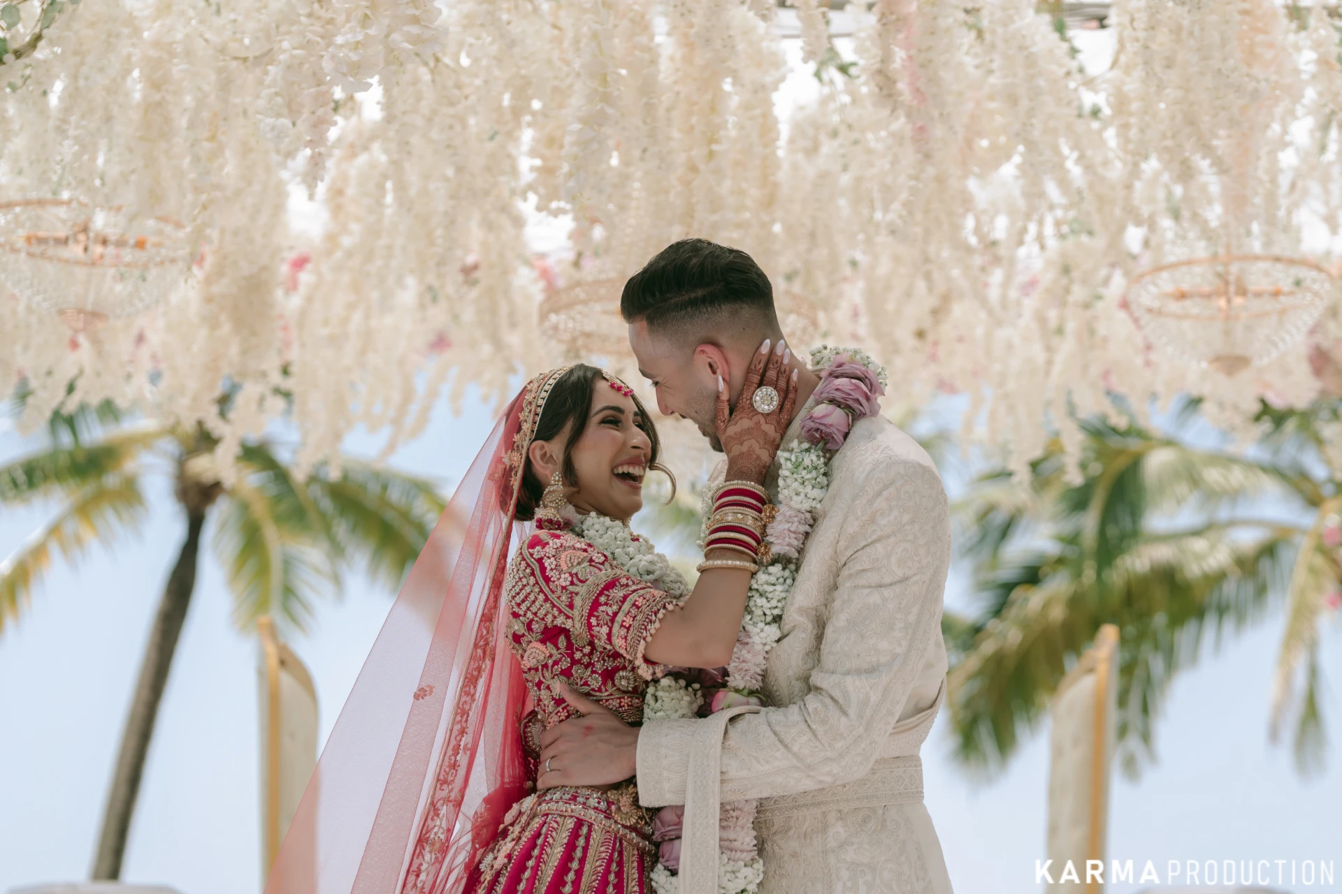 Nikki and Anuj beneath a floral canopy at their Khao Lak wedding