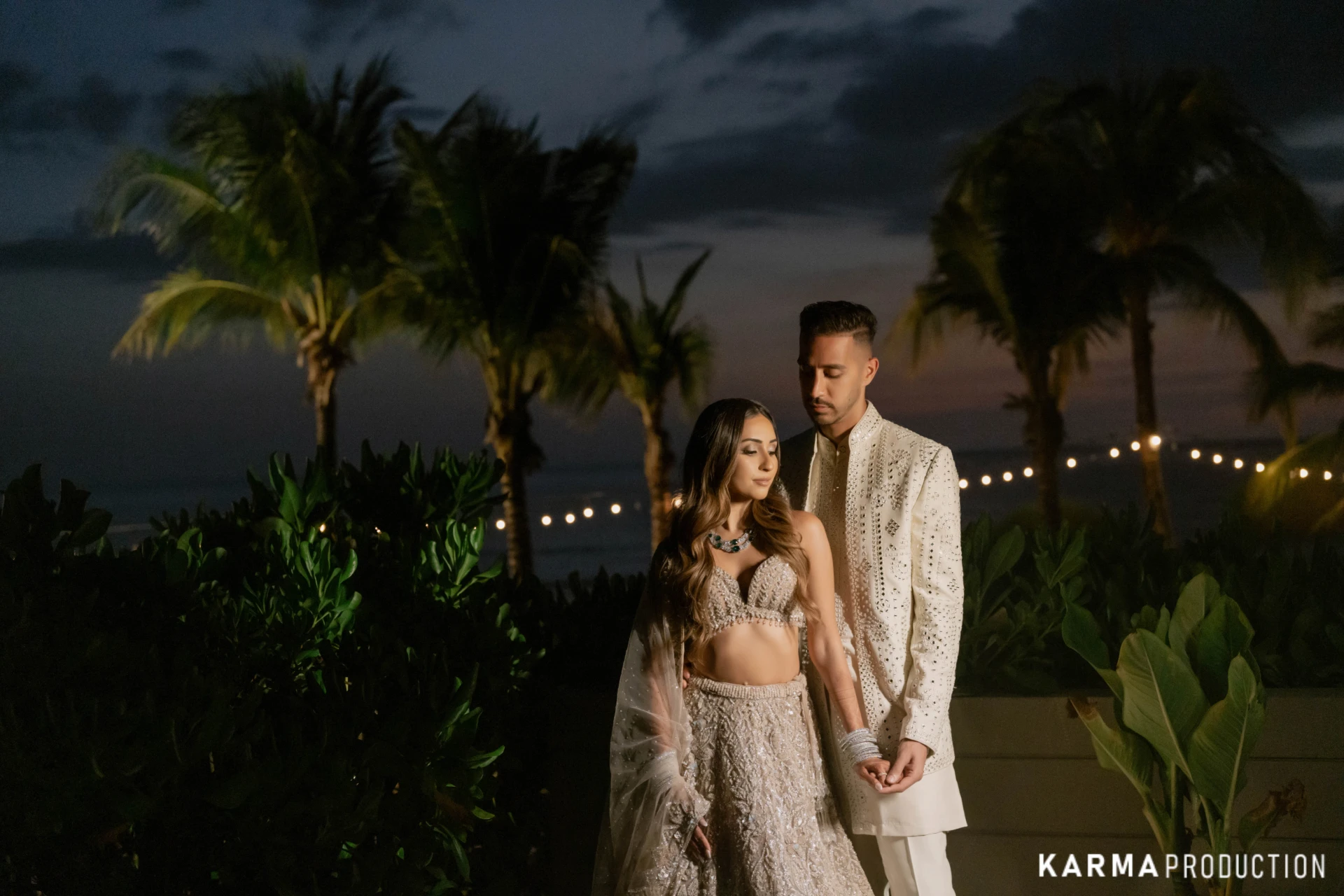 Rahul and Sakshi at dusk under string lights in Khao Lak